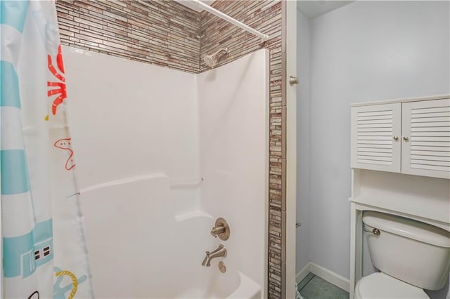 bathroom featuring shower / tub combo and toilet