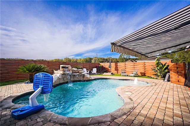 view of pool with pool water feature and a patio area