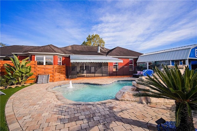 view of pool with a patio area and pool water feature