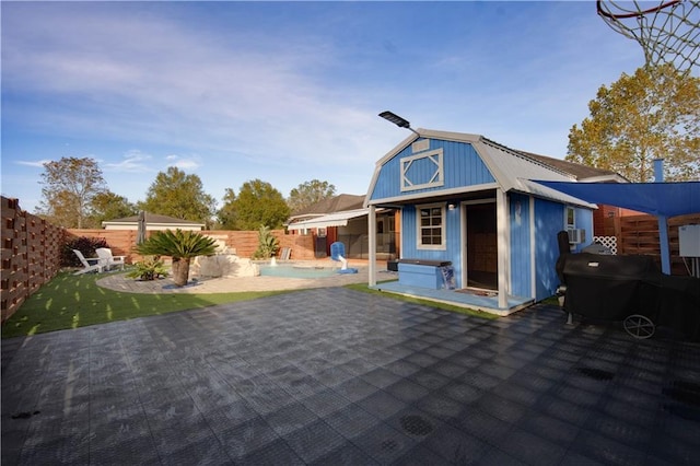 exterior space featuring a swimming pool and a patio