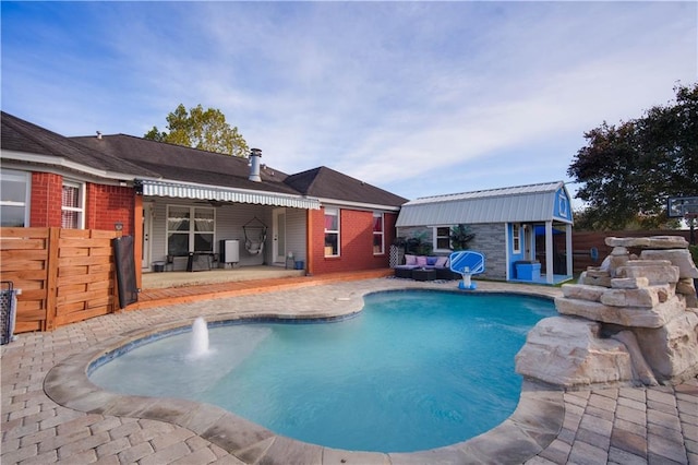 view of pool featuring a patio and an outdoor structure