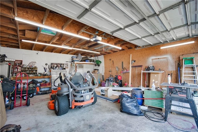 garage with a workshop area and a garage door opener