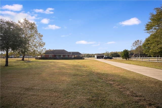 view of property's community featuring a lawn and a rural view