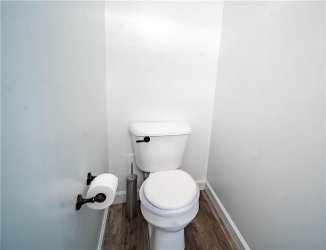 bathroom featuring wood-type flooring and toilet