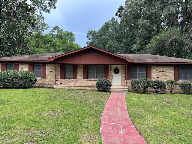 5859 Chalet Dr N, Mobile, AL 36608 - ranch-style home with a front yard, brick siding, a porch, and a shingled roof