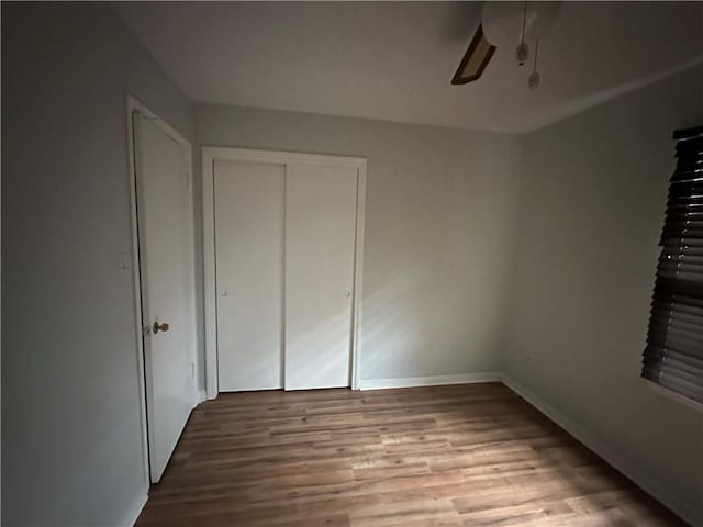 5859 Chalet Dr N, Mobile, AL 36608 - unfurnished bedroom featuring wood finished floors, a closet, and ceiling fan