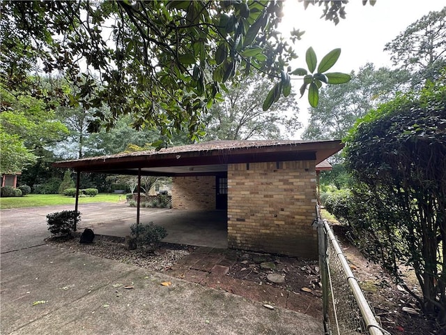 5859 Chalet Dr N, Mobile, AL 36608 - view of side of home with brick siding, driveway, and an attached carport