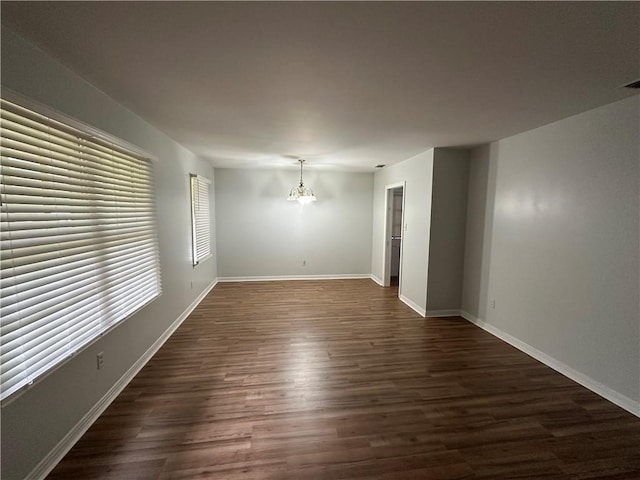 5859 Chalet Dr N, Mobile, AL 36608 - unfurnished room with dark wood finished floors and a chandelier