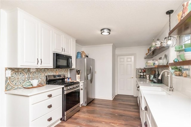 kitchen with open shelves, decorative backsplash, appliances with stainless steel finishes, white cabinetry, and wood finished floors