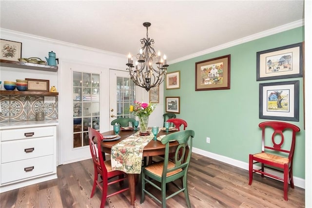 dining area with dark wood-style flooring, french doors, crown molding, a chandelier, and baseboards