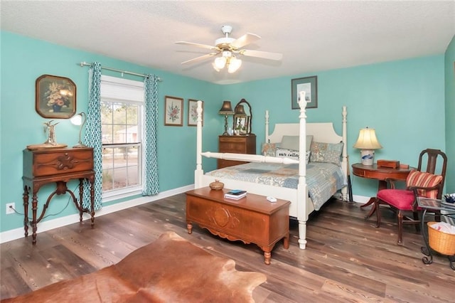 bedroom with wood finished floors, a ceiling fan, and baseboards