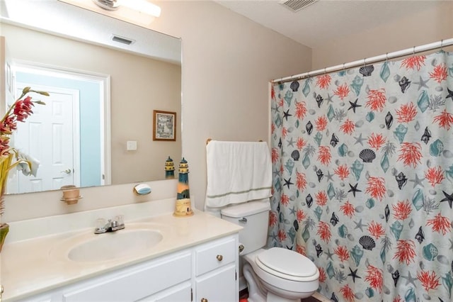 bathroom featuring visible vents, a shower with shower curtain, vanity, and toilet