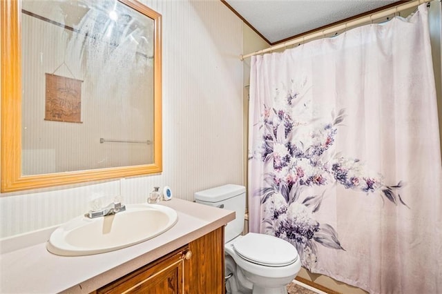 bathroom featuring a textured ceiling, vanity, toilet, and curtained shower