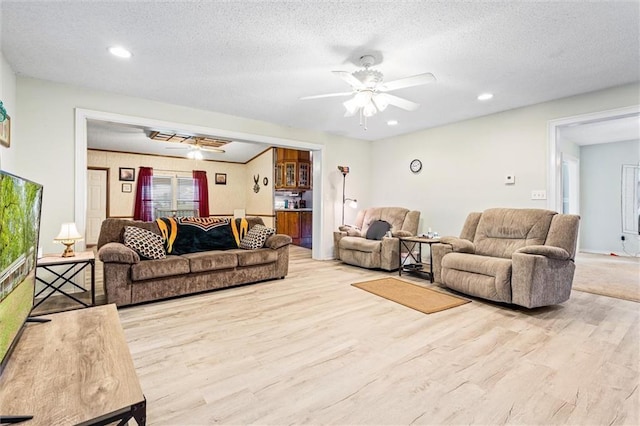 living room featuring light wood-type flooring and a textured ceiling