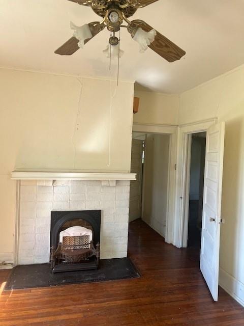 details featuring hardwood / wood-style flooring, ceiling fan, and a wood stove