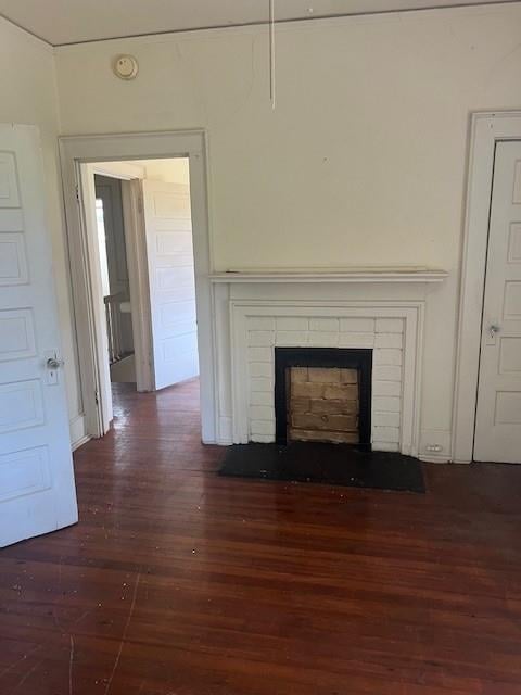 room details featuring wood-type flooring and a brick fireplace