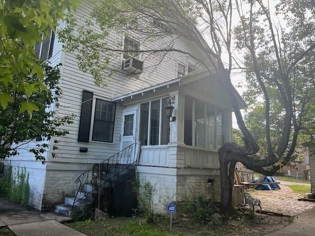 view of side of property featuring a sunroom