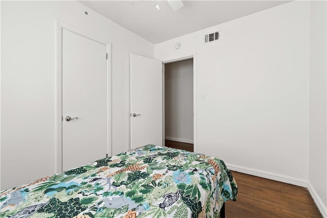 bedroom with ceiling fan and dark hardwood / wood-style floors