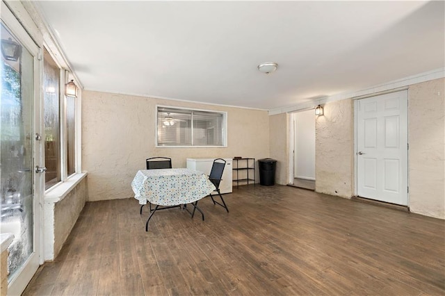 dining space with dark hardwood / wood-style flooring and ornamental molding