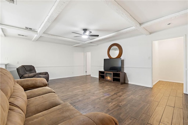 living room featuring wood-type flooring, ceiling fan, and beam ceiling