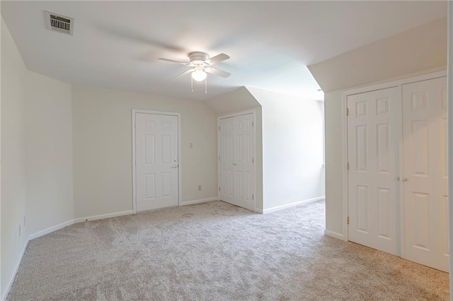 bonus room featuring ceiling fan and light colored carpet