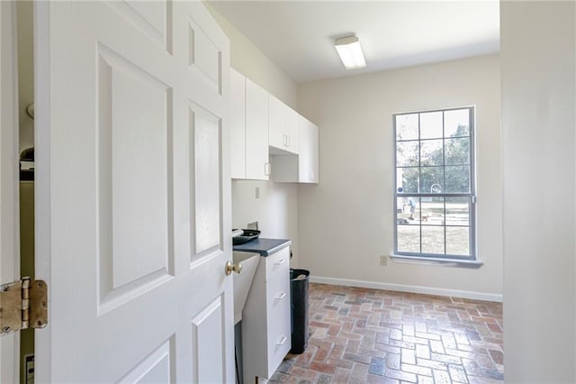 kitchen with plenty of natural light and white cabinetry