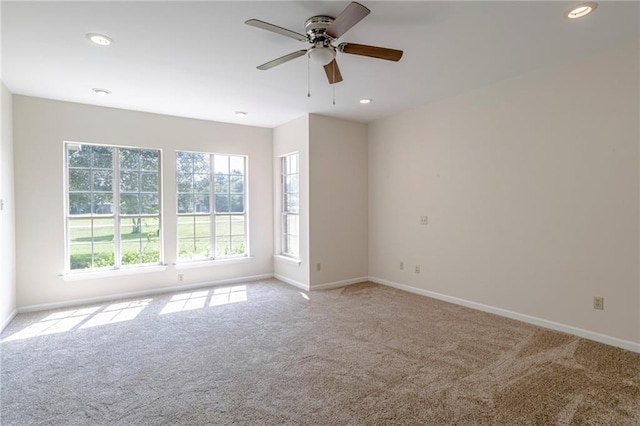 empty room featuring ceiling fan and carpet