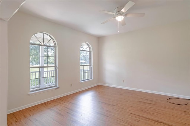 unfurnished room with light hardwood / wood-style flooring and ceiling fan