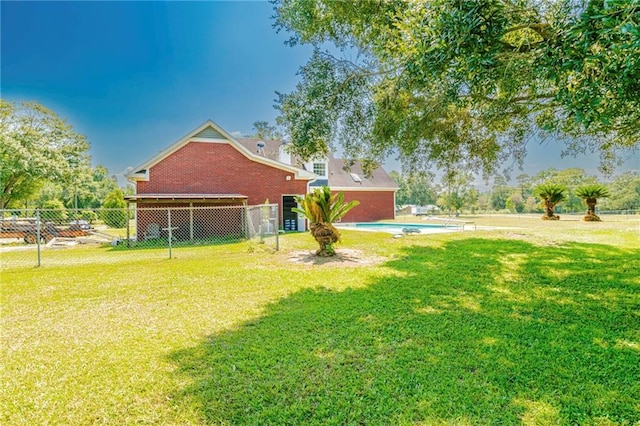 view of yard with a fenced in pool