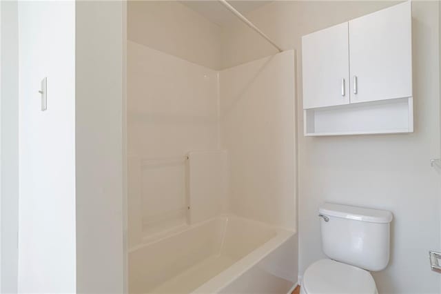 bathroom featuring shower / bathtub combination and toilet