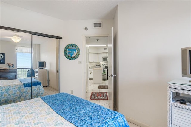 bedroom featuring light tile floors, a closet, and ceiling fan