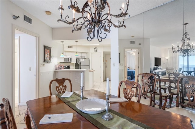 dining space featuring light tile floors and a notable chandelier