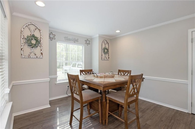 dining room featuring dark hardwood / wood-style flooring and crown molding