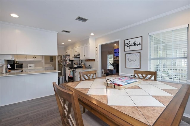 dining area with washer / clothes dryer, crown molding, and wood-type flooring