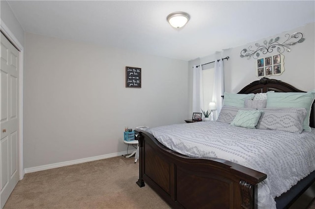 bedroom with a closet and light carpet