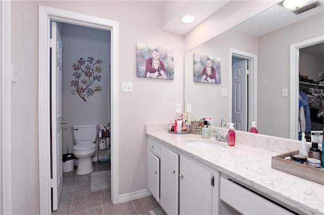 bathroom featuring tile patterned floors, vanity, and toilet