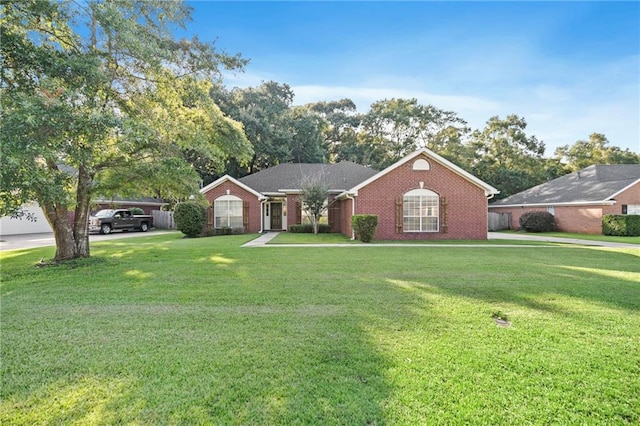 ranch-style house with brick siding and a front yard