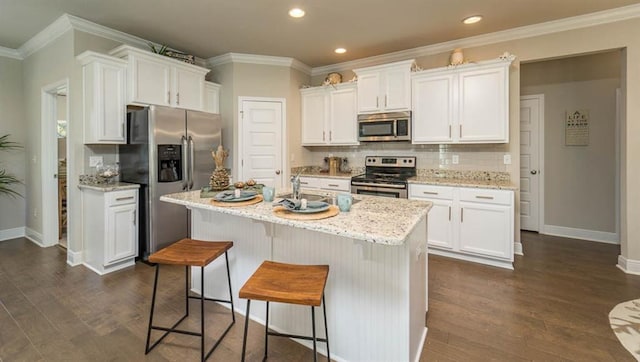 10580 Relic Rd S, Mobile, AL 36608 - kitchen featuring stainless steel appliances, white cabinets, tasteful backsplash, dark wood finished floors, and recessed lighting
