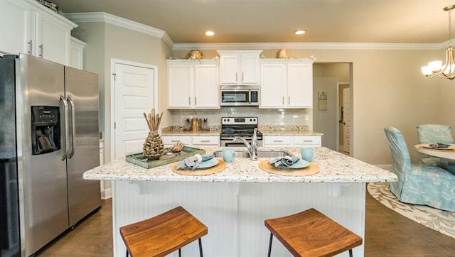10580 Relic Rd S, Mobile, AL 36608 - kitchen with appliances with stainless steel finishes, dark wood-style floors, crown molding, white cabinets, and a chandelier