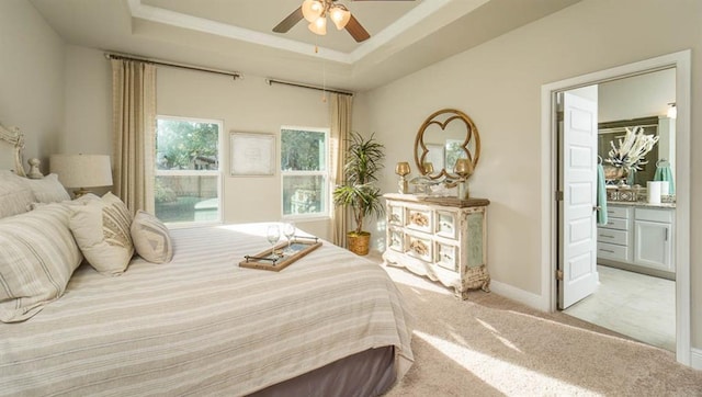 10580 Relic Rd S, Mobile, AL 36608 - bedroom featuring light colored carpet, a tray ceiling, a ceiling fan, and connected bathroom