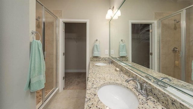 10580 Relic Rd S, Mobile, AL 36608 - full bathroom with a spacious closet, double vanity, a shower stall, and tile patterned flooring