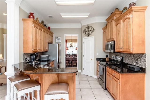9633 White Castle Rd, Mobile, AL 36695 - kitchen featuring stainless steel appliances, a peninsula, light tile patterned floors, a breakfast bar, and backsplash