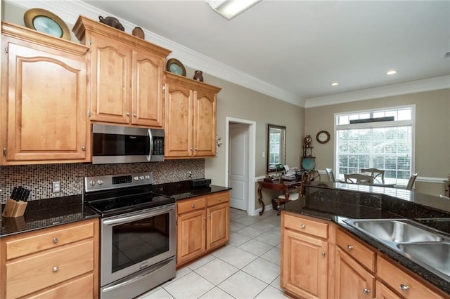 9633 White Castle Rd, Mobile, AL 36695 - kitchen featuring appliances with stainless steel finishes, decorative backsplash, light tile patterned flooring, dark stone counters, and ornamental molding