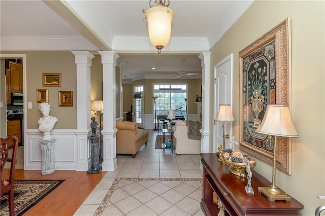 9633 White Castle Rd, Mobile, AL 36695 - foyer featuring decorative columns, a ceiling fan, a wainscoted wall, ornamental molding, and light tile patterned flooring