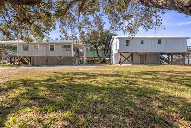 back of property featuring a lawn