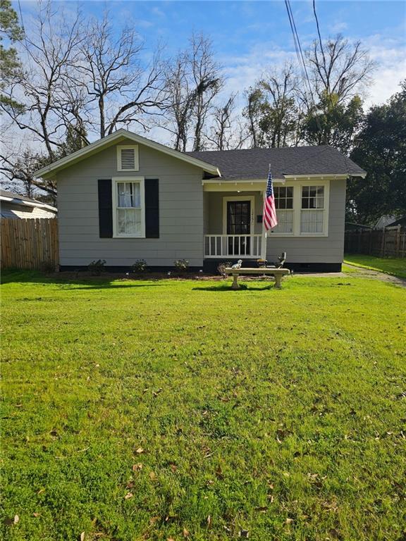 ranch-style home with fence and a front lawn