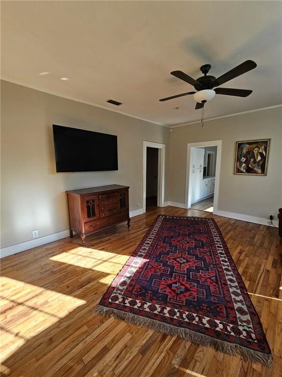 living room with visible vents, crown molding, and light wood-style flooring