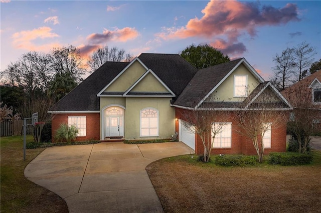 view of front facade with a garage and a yard