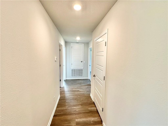 hall with dark hardwood / wood-style flooring