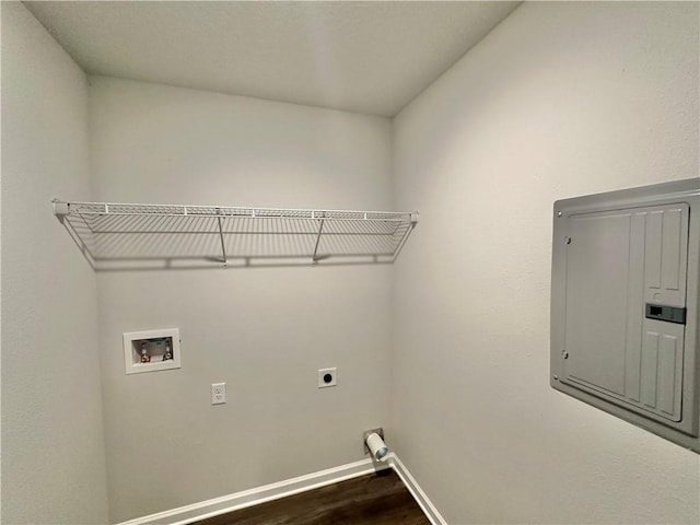 washroom with hookup for an electric dryer, dark hardwood / wood-style floors, hookup for a washing machine, and electric panel